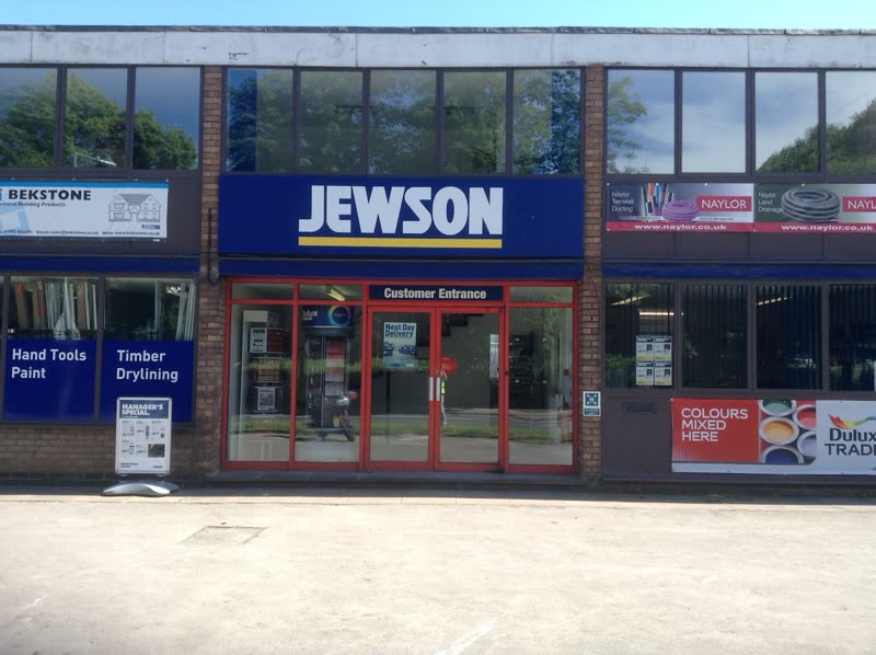 The Jewson Witney trade counter on Station Lane, brick and glass frontage with customer entrance